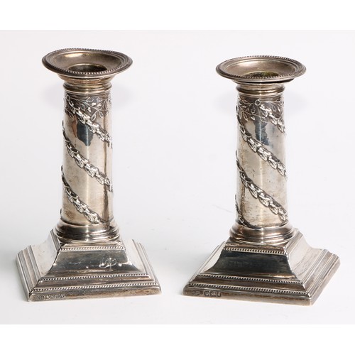 1034 - A pair of Victorian silver columnar candlesticks, in the Neo-Classical taste, beaded borders, steppe... 