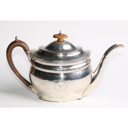 936 - A George III silver oval teapot, hinged domed cover, bright-cut and wrigglework engraved, fruitwood ... 