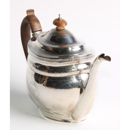 936 - A George III silver oval teapot, hinged domed cover, bright-cut and wrigglework engraved, fruitwood ... 