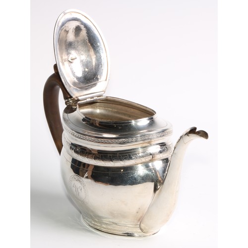 936 - A George III silver oval teapot, hinged domed cover, bright-cut and wrigglework engraved, fruitwood ... 