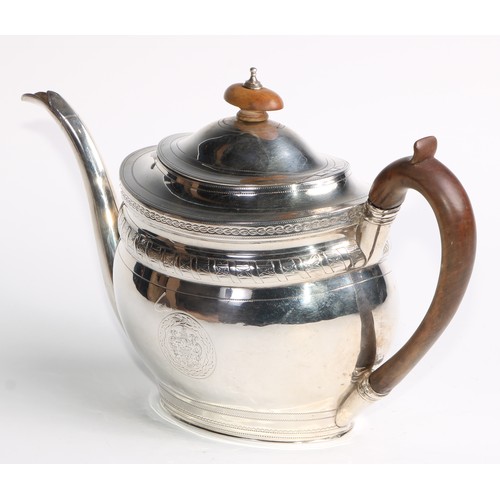 936 - A George III silver oval teapot, hinged domed cover, bright-cut and wrigglework engraved, fruitwood ... 