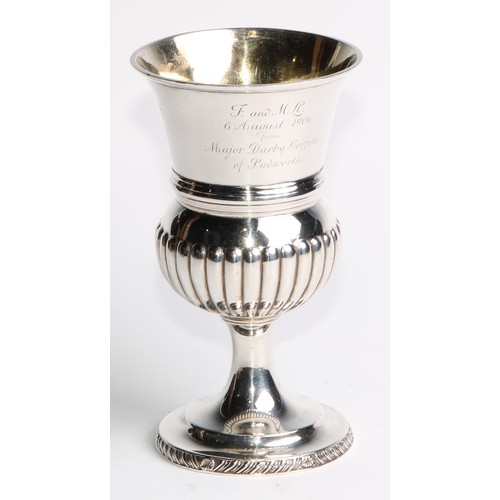 923 - A George III silver half fluted campana pedestal wine goblet, domed circular base with gadrooned bor... 