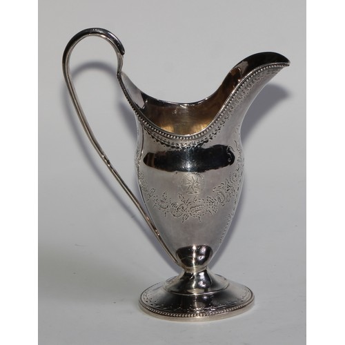 911 - A George III Scottish silver helmet shaped pedestal cream jug, bright-cut engraved in the Neo-Classi... 