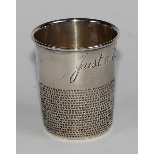 1125 - An American silver novelty whisky tot or stirrup cup, as a thimble, inscribed Just a Thimbleful, gil... 