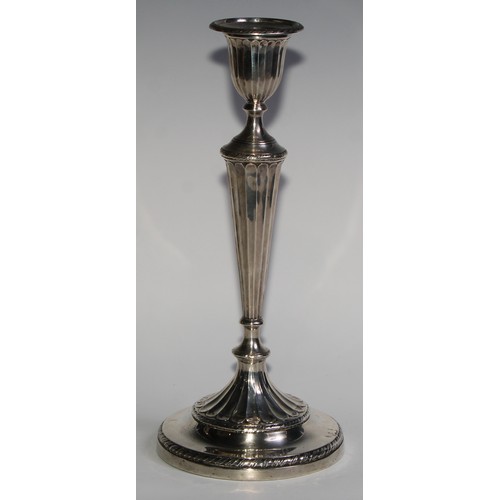 1038 - A pair of Victorian silver table candlesticks, in the Adam Revival taste, urnular sconces with detac... 