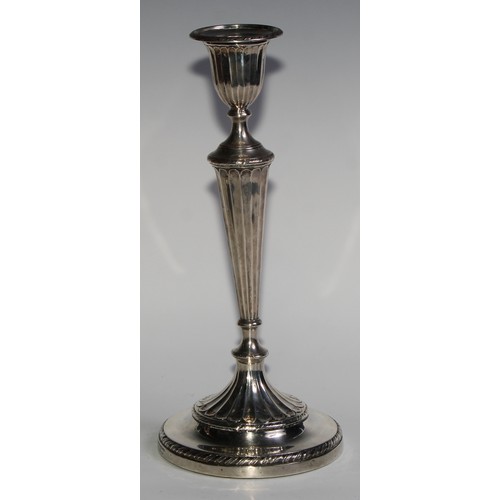 1038 - A pair of Victorian silver table candlesticks, in the Adam Revival taste, urnular sconces with detac... 