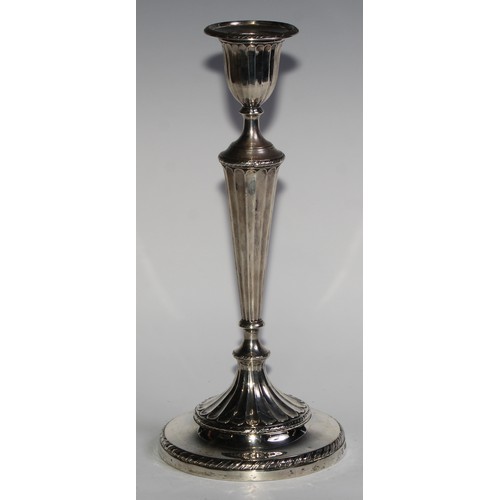 1038 - A pair of Victorian silver table candlesticks, in the Adam Revival taste, urnular sconces with detac... 