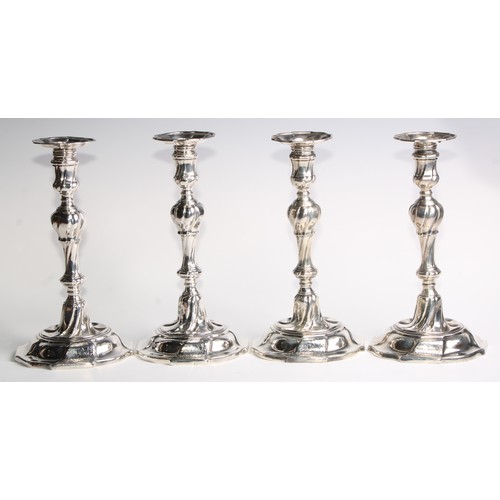 1055 - A set of four George II silver table candlesticks, wrythen pillars, piecrust nozzles and bases, 26.5... 