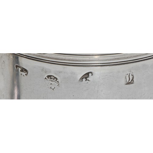 1147 - An early George II silver spreading cylindrical mug, S-scroll handle, three-quarter girdle, skirted ... 