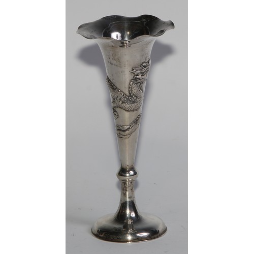 1013 - A pair of Chinese silver trumpet shaped specimen vases, chased with dragons, domed bases, 15cm high,... 