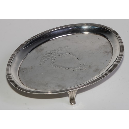 1255 - The Bateman Family - a George III silver oval teapot stand, reeded border, the field bright-cut and ... 