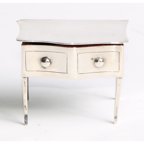 964 - A George V silver novelty dressing table jewellery box, as a serpentine side table, hinged cover abo... 