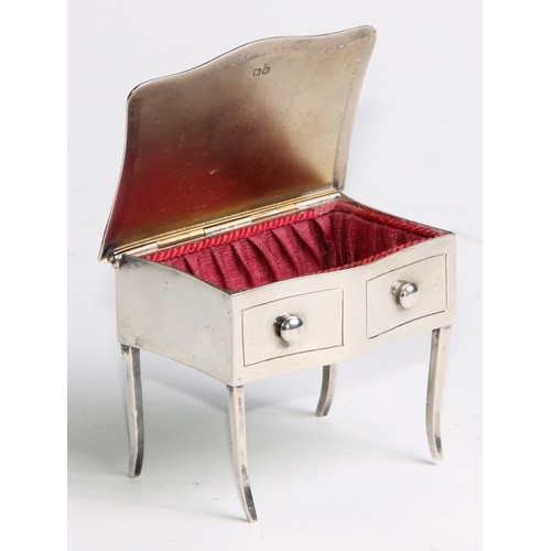 964 - A George V silver novelty dressing table jewellery box, as a serpentine side table, hinged cover abo... 