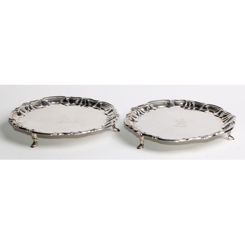 1025 - A pair of George II silver shaped circular salvers, fluted shell and C-scroll borders, pad feet,  16... 