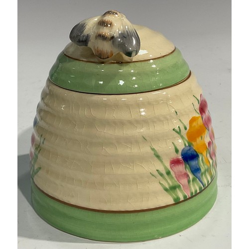 14 - A Clarice Cliff Spring Crocus pattern ribbed domed honey pot and cover, the cover with bee knop, 10c... 