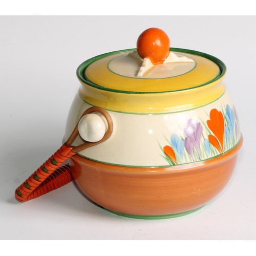 12 - A Clarice Cliff Crocus pattern biscuit barrel and cover, painted in bright colours, wicker handle, 1... 