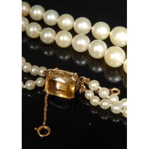 1531 - Tallulah Bankhead - A two strand graduated pearl necklace, the clasp stamped '14K' for 14ct, set wit... 