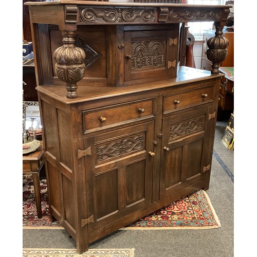 81 - A carved oak court cupboard, 138cm high x 127cm wide x 44cm.