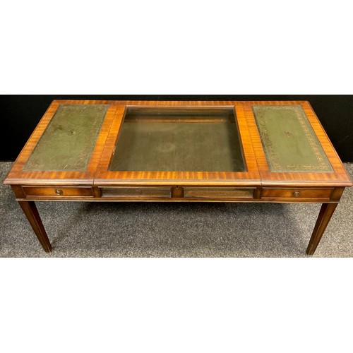 83 - A 20th century mahogany Bijouterie centre coffee table, tooled green leather inset top, lift-up glaz... 