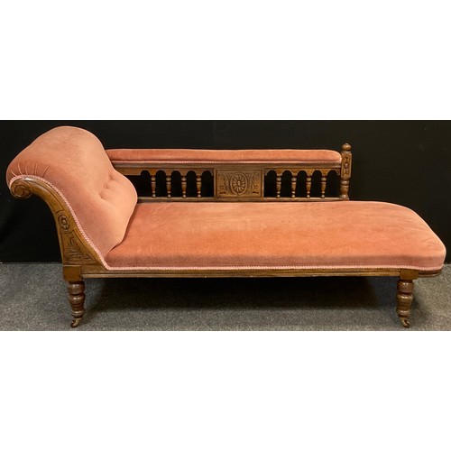 112 - A Victorian oak scroll-end Chaise Longue, carved scroll, turned supports with ceramic casters, uphol... 