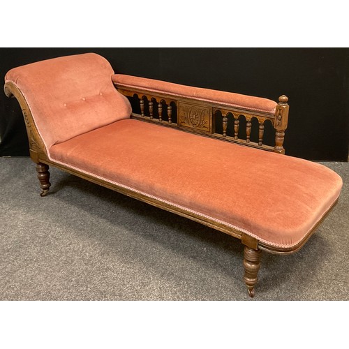 112 - A Victorian oak scroll-end Chaise Longue, carved scroll, turned supports with ceramic casters, uphol... 