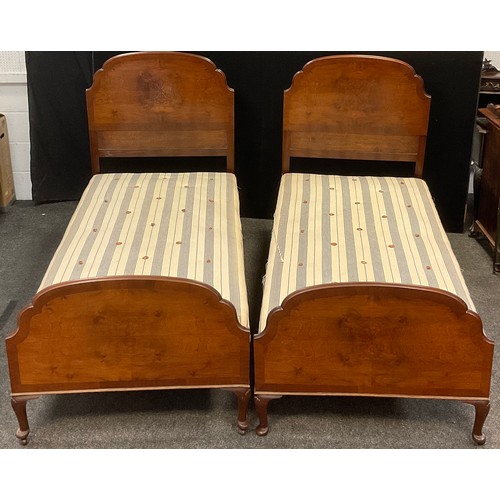 374 - A pair of early to mid 20th century single beds - walnut head and foot boards, cast iron side rails,... 