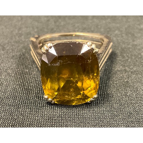 544 - An orangy brown single stone dress ring, possibly a zircon, unmarked white metal shank, 11.4g gross