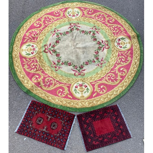 387A - A large circular woollen rug or carpet, floral swags and reserves with urns and flowers, in shades o... 