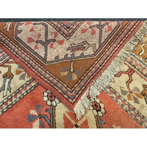 324A - A Middle Eastern wool rug / carpet, knotted in subtle tones of blue, ochre, pink and white, 260cm x ... 