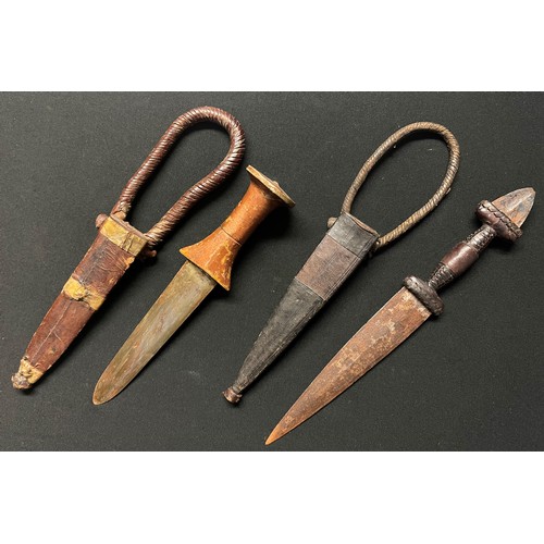 4056 - Two African Sleeve Daggers: one with gold painted wooden grip with 134mm long double edged blade, ov... 