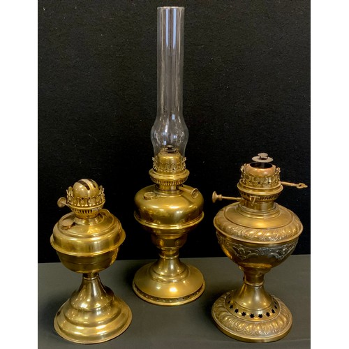 32 - A French brass oil lamp, embossed ornate body and reservoir, marked Lampe Veritas;  others Belgian, ... 