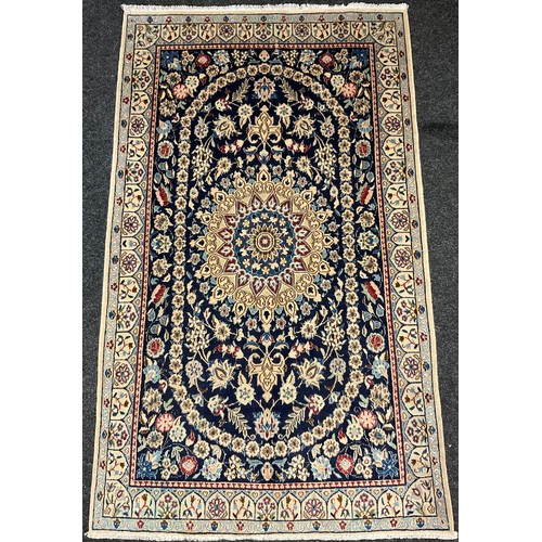 58 - A Central Persian wool and silk Nain rug / carpet, hand-knotted with a central lotus-form medallion ... 