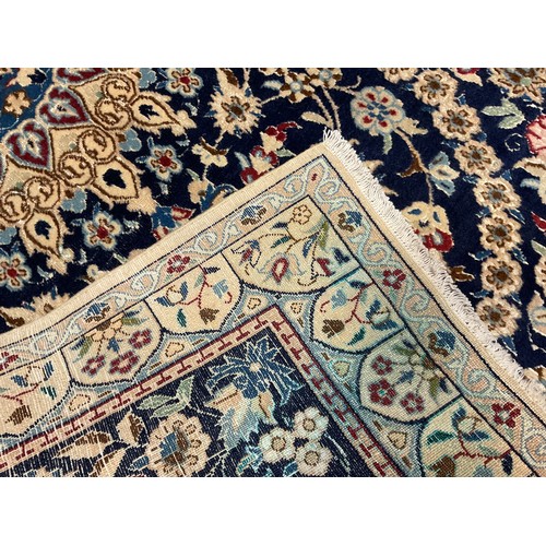 58 - A Central Persian wool and silk Nain rug / carpet, hand-knotted with a central lotus-form medallion ... 