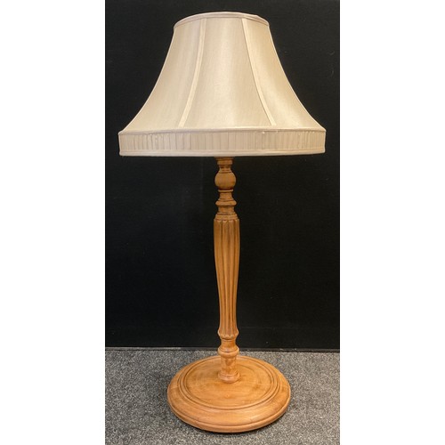 66 - A large walnut table lamp, turned and reeded column, circular base, 97cm high x 35cm diameter (at ba... 