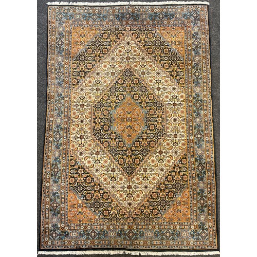 67 - A Persian Moud rug, hand-knotted, hexagon-shaped medallion, in subdued tones of blue, red, and cream... 