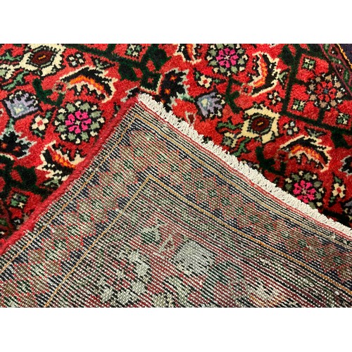 72 - A North West Persian Malayer Runner carpet, knotted with stylised floral motifs in black, green, mau... 