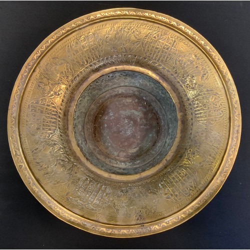 73 - A 19th century Persian brass dish, engraved, embossed and chased with animals and text, 36cm in diam... 