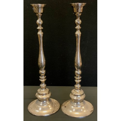 81 - Interior design - An impressive pair of steel candlesticks, 64cm high