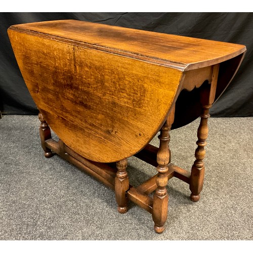 84 - A Titchmarsh and Goodwin oak gate leg table, model RL8, 74cm high x 137cm wide (leaves open), 41cm (... 