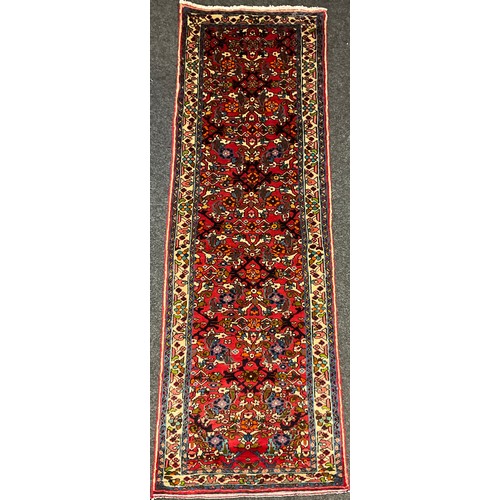 86 - A North West Persian Rudbar runner carpet, knotted with a dense stylised floral field, in shades of ... 