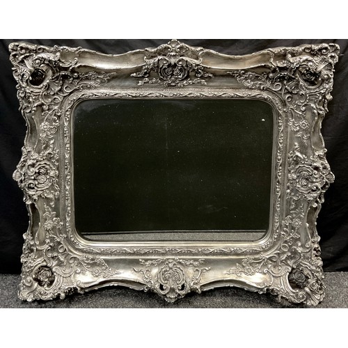 114 - A large regency style wall mirror, rounded rectangular bevelled plate, silvered swept frame with flo... 