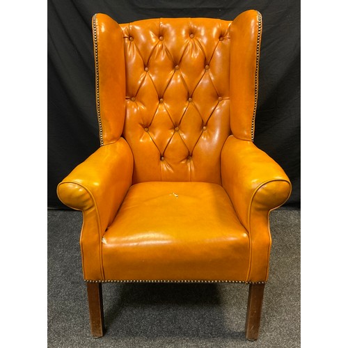 158 - A Chesterfield wing-back office armchair, button back, warm ochre leather, square legs, 110cm high x... 