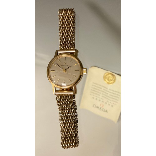 1010 - Omega - a lady's 9ct gold cased bracelet wristwatch, silvered dial, block baton markers, mechanical ... 