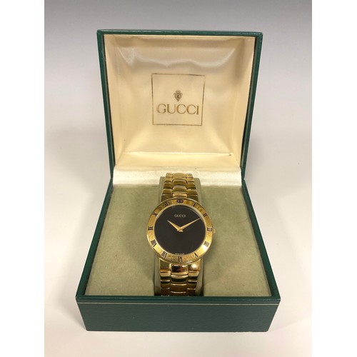 1133 - Gucci - 3300.2.M gold plated dress wristwatch, 32mm case, black dial, gold hands, Roman numeral beze... 