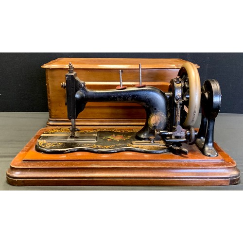 462 - A Bradbury and Co hand crank Sewing machine, reg no.F120451, cased,c.1890