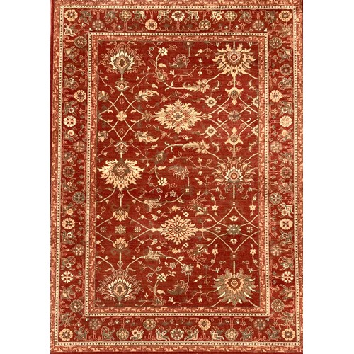 476 - A Chinese rug, all over floral motifs in blue and cream on a rust ground, approx 195cm x 140cm.