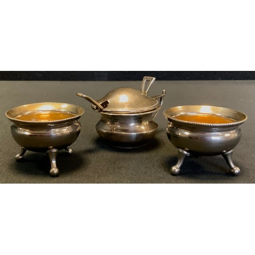 552 - A silver mustard pot, Birmingham 1918; pair of silver plated cauldron salts (3)