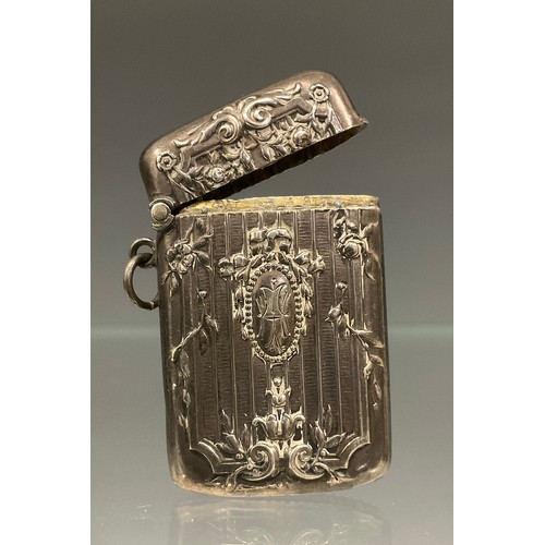 560 - A French silver coloured metal rectangular vesta case, embossed in neo-classical style, c.1910