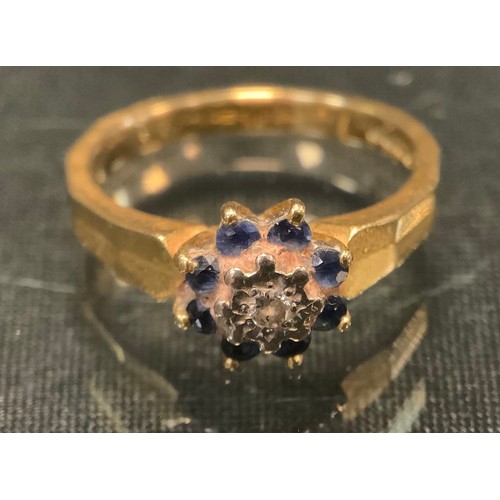 597 - A diamond sapphire cluster ring, 18ct gold shank, size N, 5.2g gross.