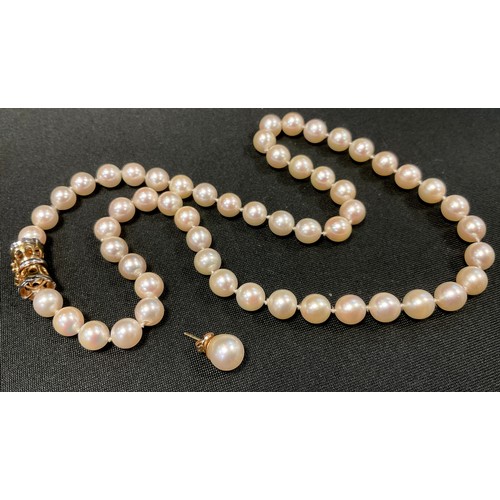 639 - A cultured pearl single strand necklace, approx 7mm diameter, united by an 18ct gold clasp, with sin... 